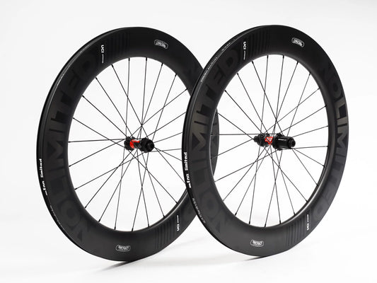Pair of black bicycle wheels with visible branding on a white background