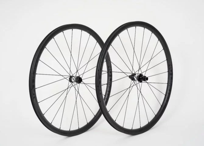 Two bicycle wheels on a white background