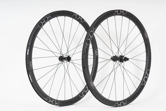 Pair of black bicycle wheels with a white background