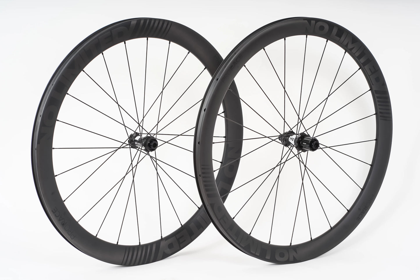 Two bicycle wheels with black rims and spokes on a white background