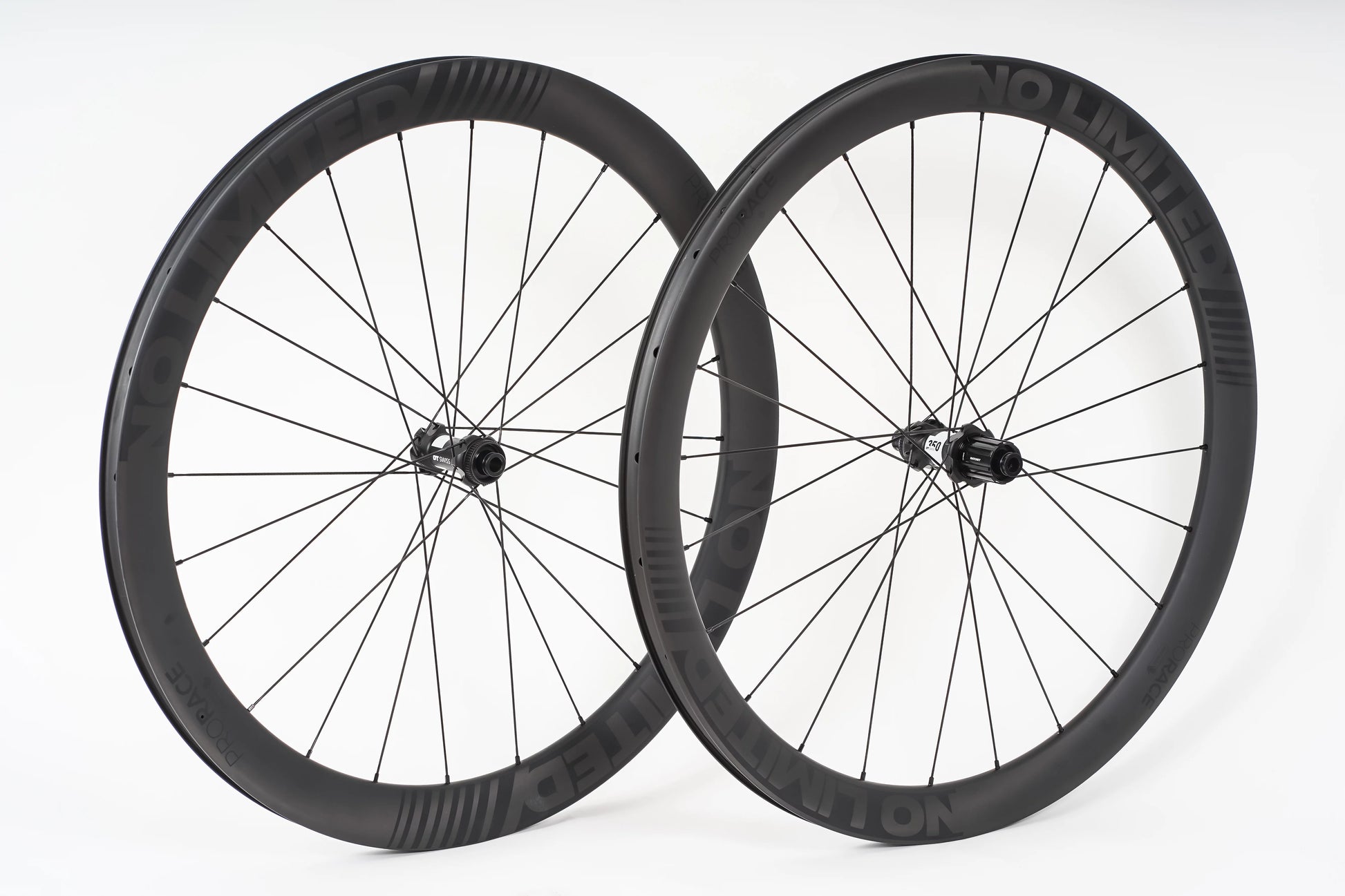 Two bicycle wheels with black rims and spokes on a white background