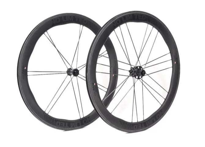 Two black bicycle wheels on a white background