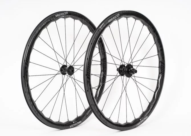 Two bicycle wheels with black rims and spokes on a white background