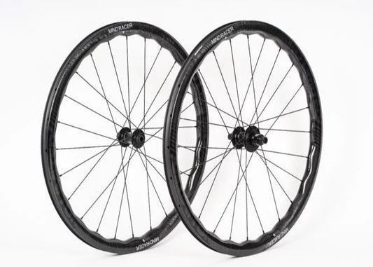 Two bicycle wheels with black rims and spokes on a white background