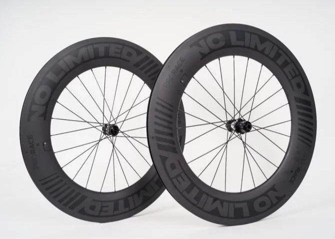 Two black bicycle wheels with 'NC Limited' branding on a white background