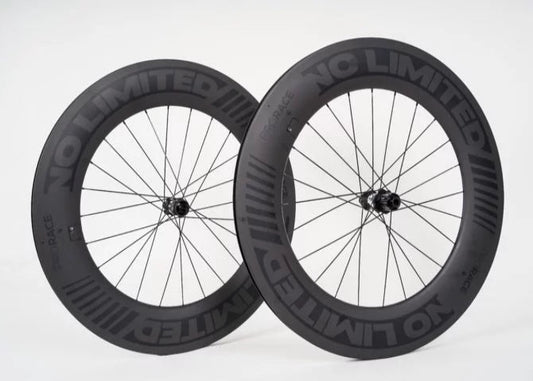 Two black bicycle wheels with 'NC Limited' branding on a white background