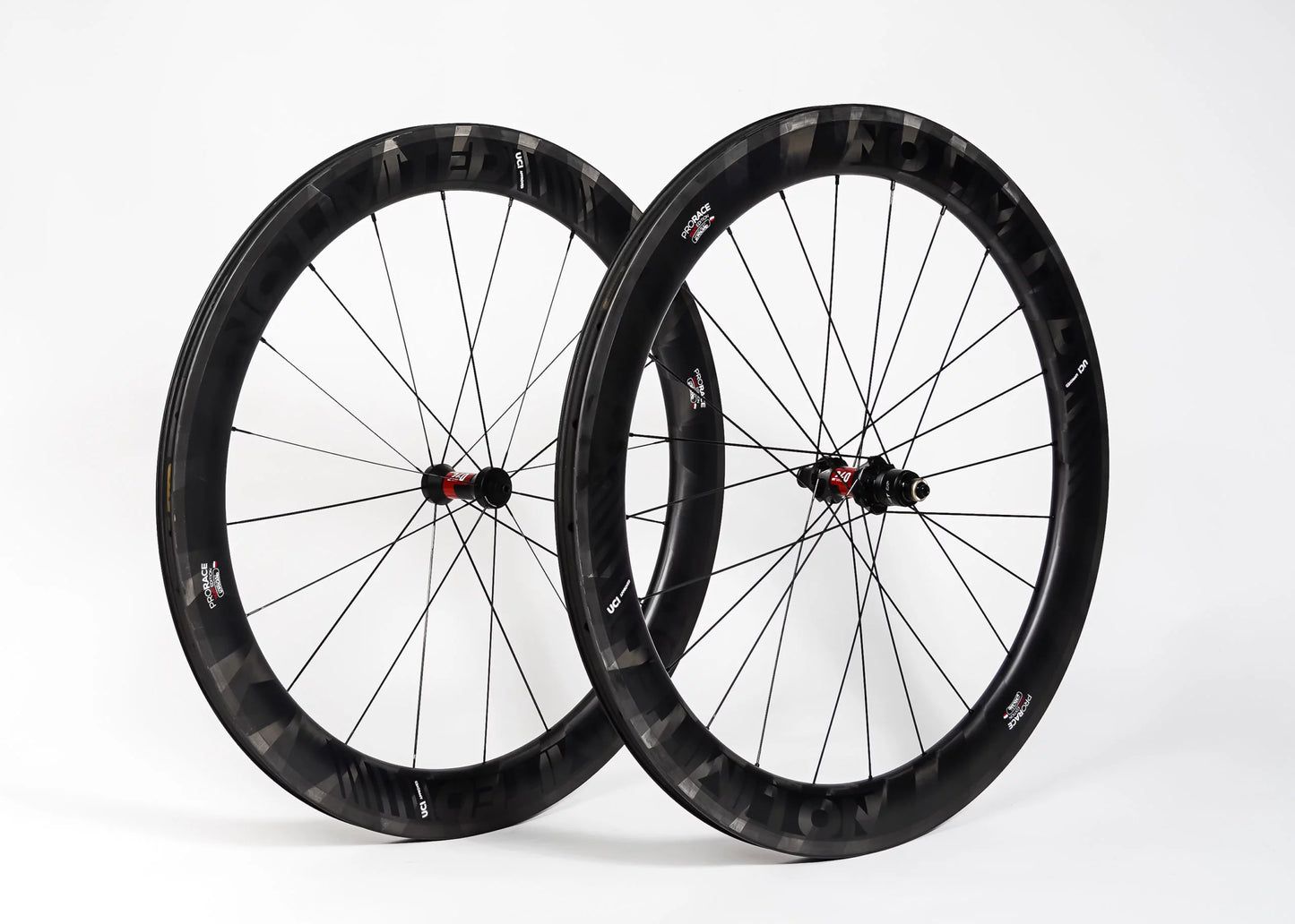 Two black bicycle wheels on a white background